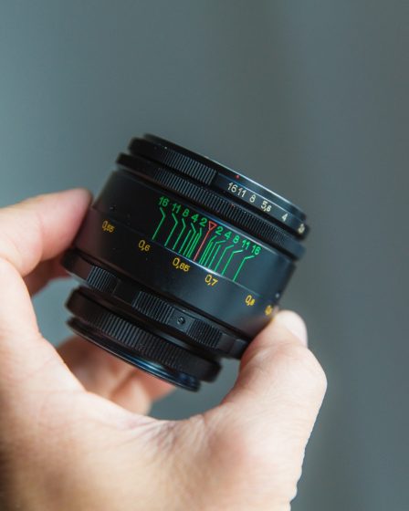 person holding black camera lens