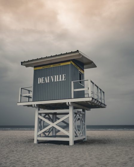 a lifeguard tower sitting on top of a sandy beach