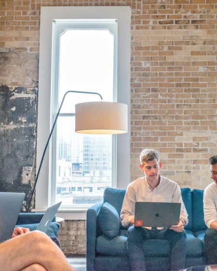 three men using MacBooks