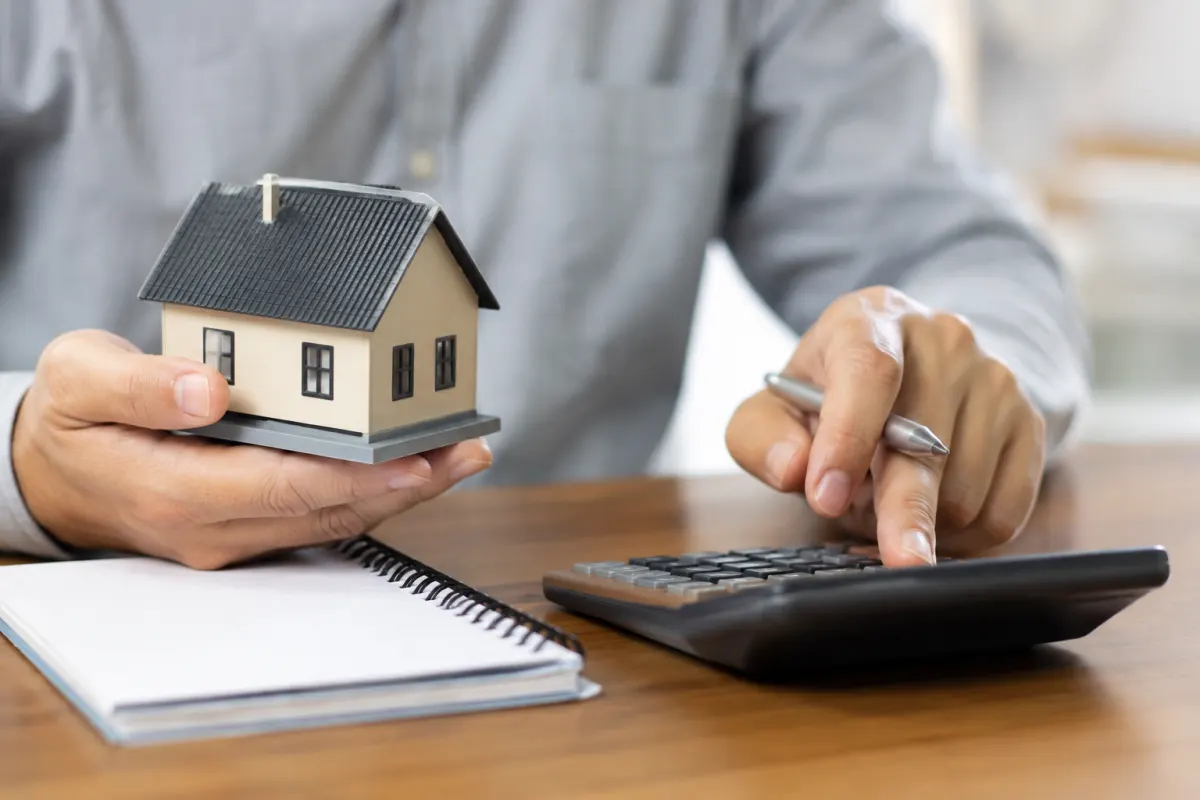 Rachat de crédit pour propriétaire : regroupez vos dettes sans risquer votre bien Gros plan sur un stylo posé sur une feuille de calcul détaillant les mensualités d un prêt